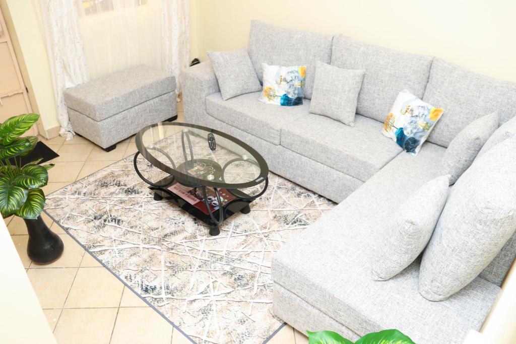 a living room with a couch and a table at Solace Park Apartments in Gatunga