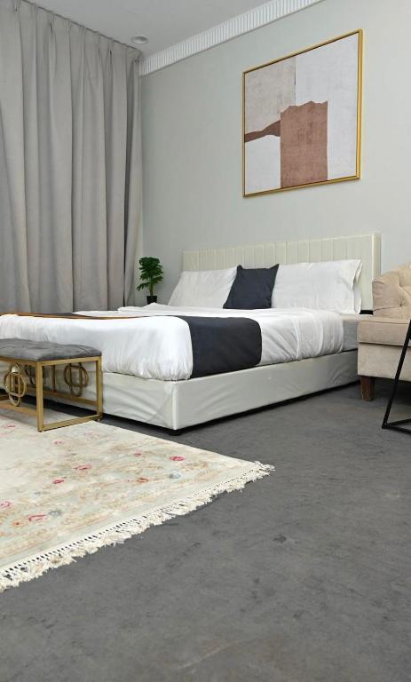 a bedroom with a large bed and a couch at قرطبه مودرن - قريبة من المطار in Riyadh