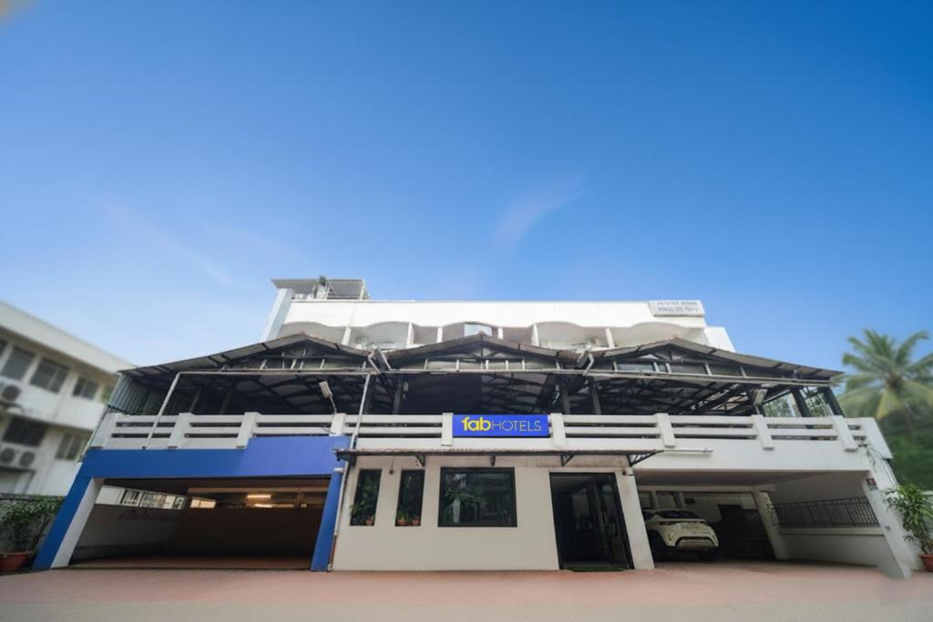 a building with a sign on the front of it at FabHotel A&M - Nr LV Prasad Institute, Banjara Hills in Hyderabad