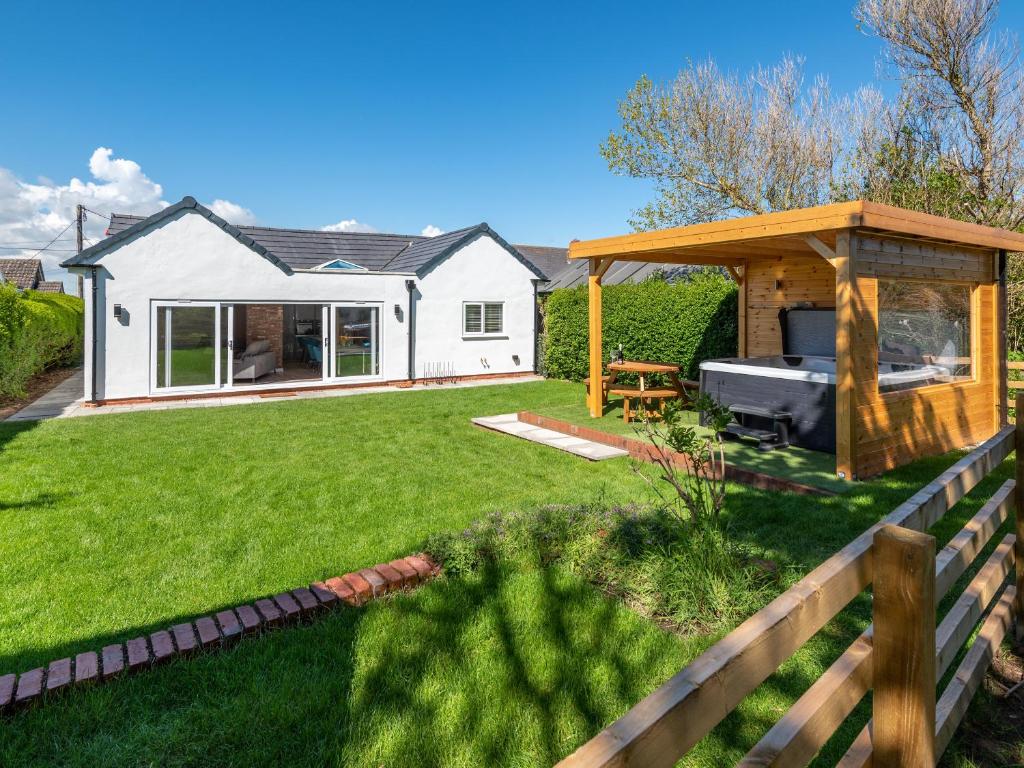a backyard with a gazebo and a house at Sea Breezes in Anderby