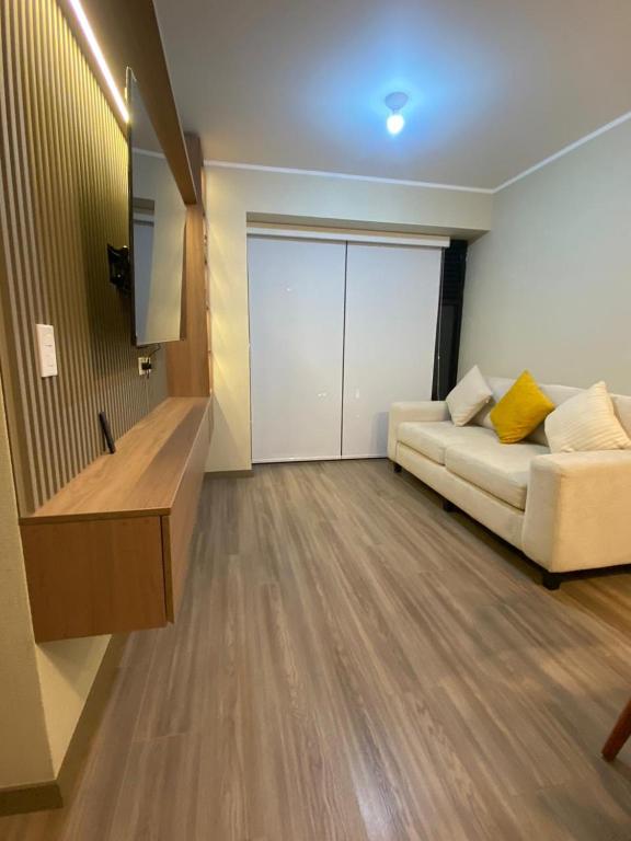 a living room with a couch and a sliding door at La Foret in Lima