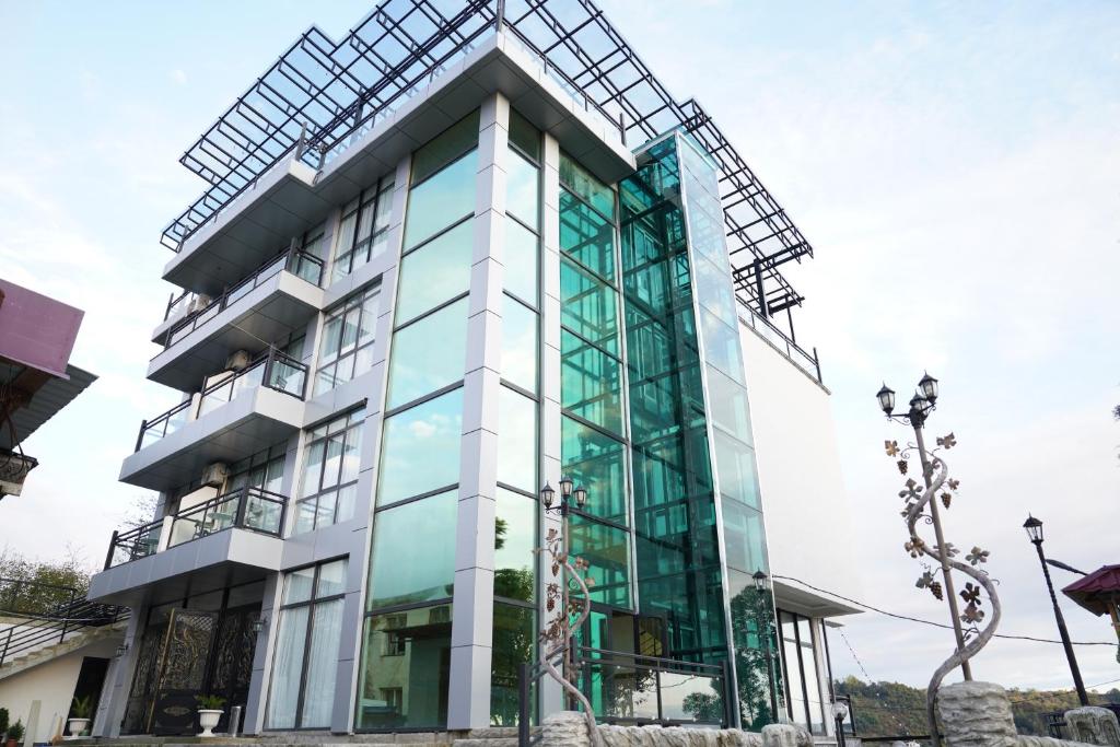 a building with a glass facade at Hotel Kochana in Chʼkhorotsqu