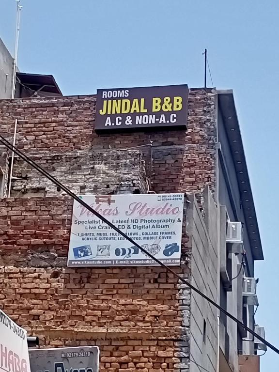 a sign on the side of a brick building at Jindal homestay in Amritsar