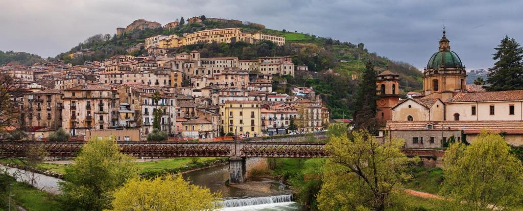 a bunch of buildings on a hill with a bridge at IELLE Suite Brutia in Cosenza
