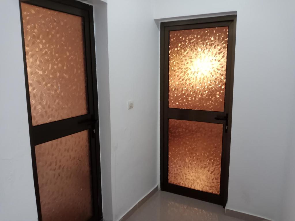 a pair of glass doors in a room at Villa BLESSING in Komé