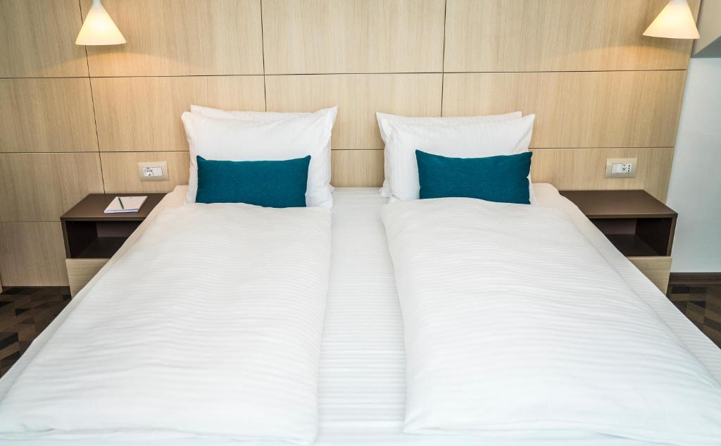 Postel nebo postele na pokoji v ubytování Hotel Kapetanovina