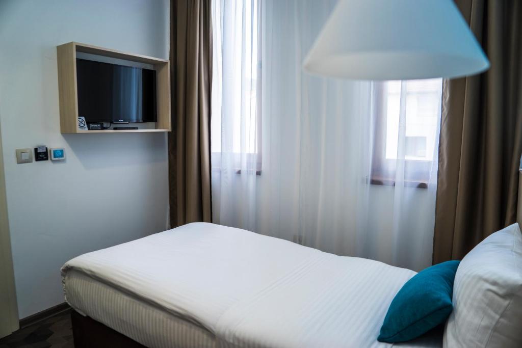 Postel nebo postele na pokoji v ubytování Hotel Kapetanovina