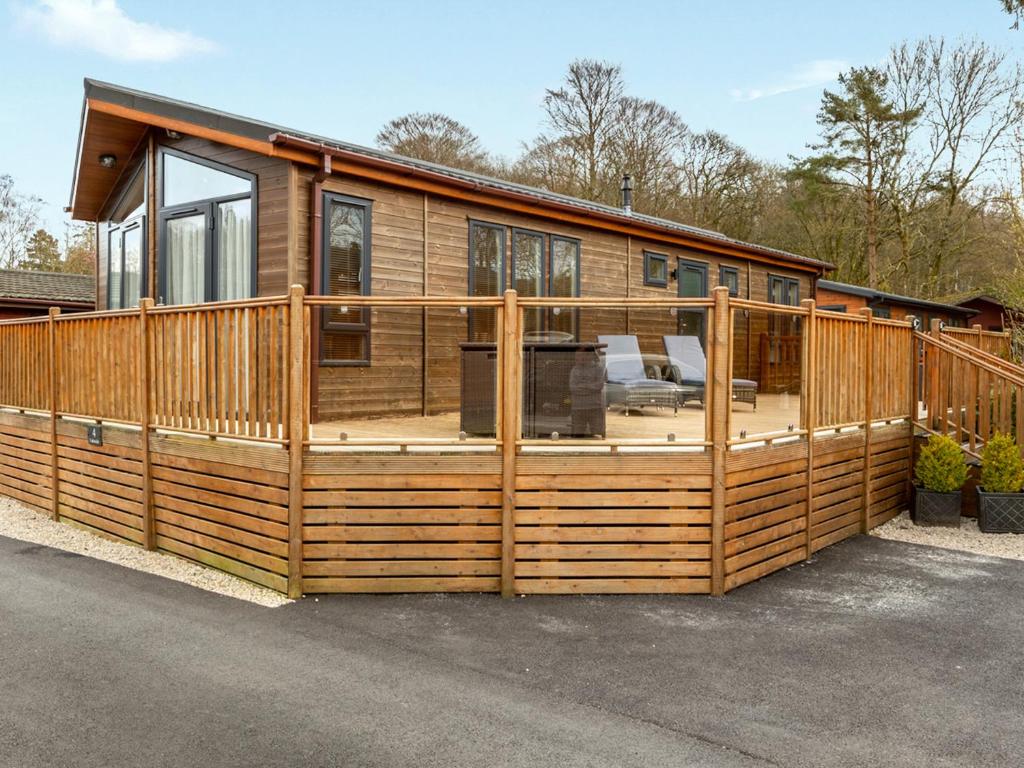 a large wooden house with a large deck at 4 Lakeside Lodge in Troutbeck Bridge