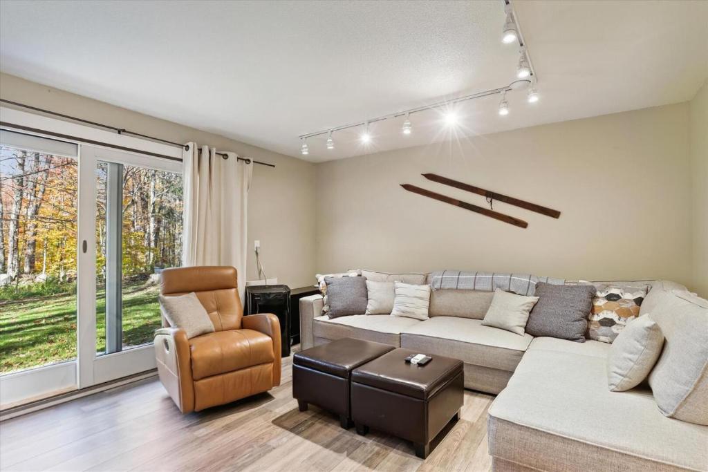 a living room with a couch and a chair at Edgemont C1 in Killington Village