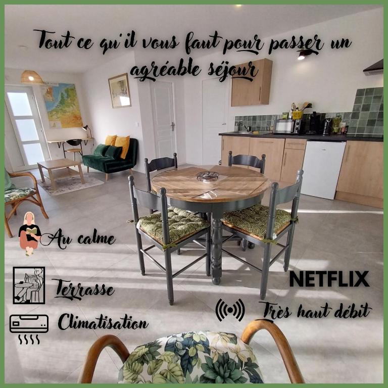 a kitchen with a table and chairs in a room at Les Blés d'Or - Parking privé, Terrasse, Clim, Netflix, Au Calme in Hem-Lenglet