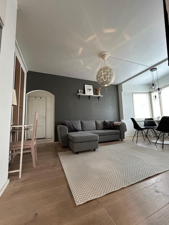 a living room with a couch and a table at Harmony two-room condo near bus- and railwaystation in Turku