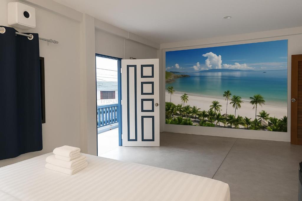 a bedroom with a large mural of a beach at Mt Olympus Retreat Hotel in Mae Nam