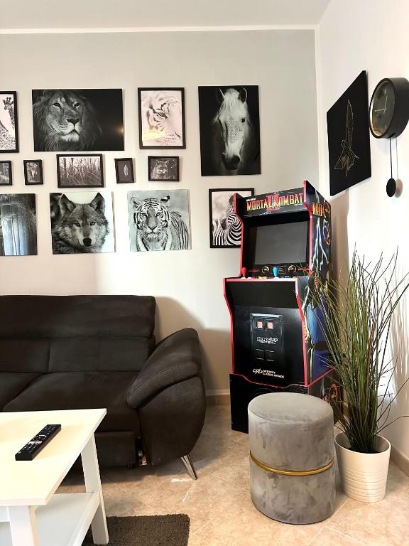 a living room with a black couch and pictures on the wall at Modern apartment - Salento Guest House in Monteroni di Lecce