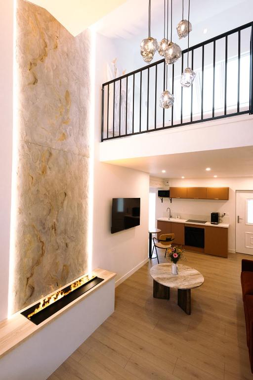 a living room with a fireplace in the wall at Les Eclats d'Amour in Chargé