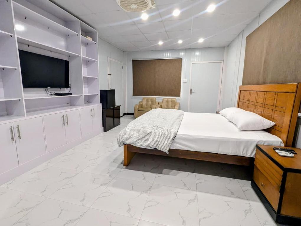 a bedroom with a bed and a flat screen tv at Dhan Valley Guest House in Bhaun
