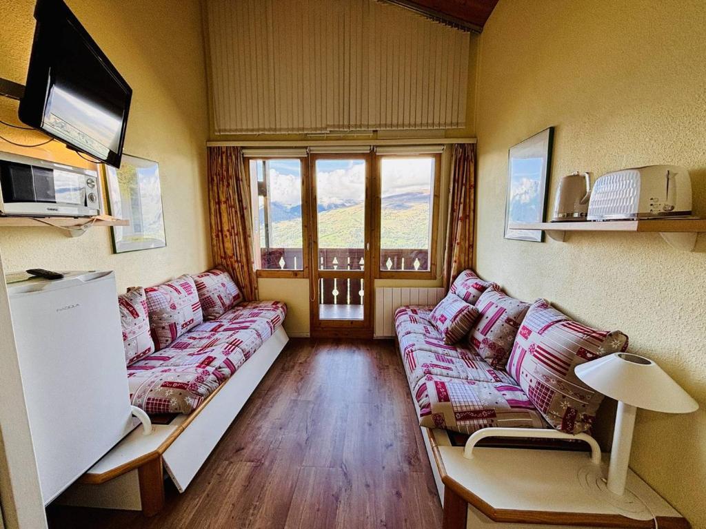 a living room with couches and a large window at Appt cosy 5 pers à La Plagne, proche pistes, animaux admis - FR-1-353-57 in La Plagne