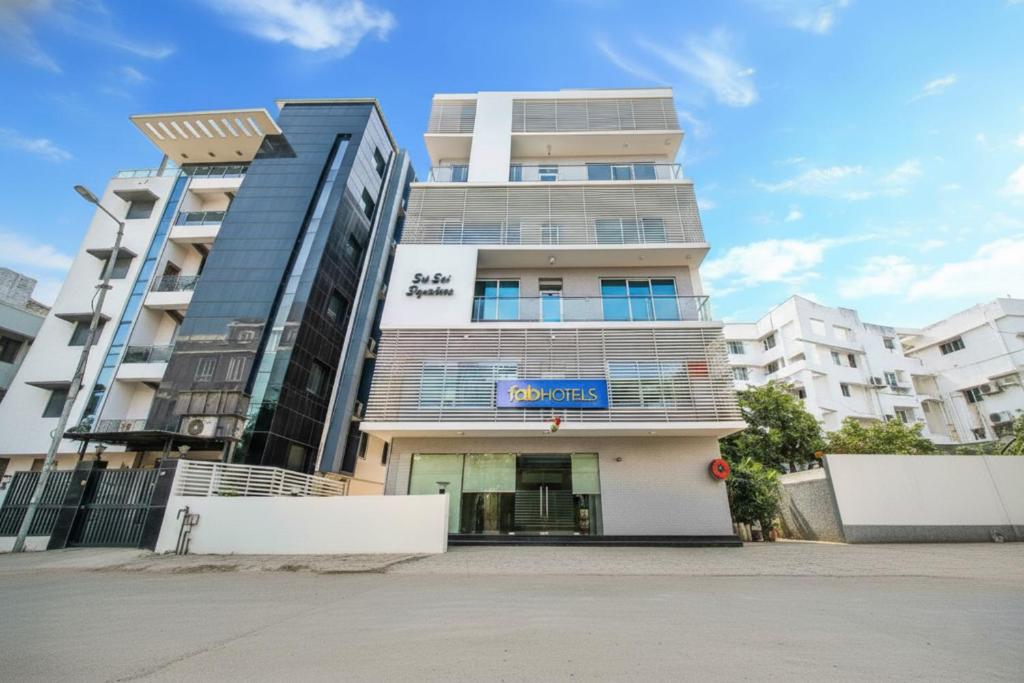 a building with a sign in front of it at Fabhotel Pearl City - Nr Jubilee Enclave, Hitech City in Hyderabad