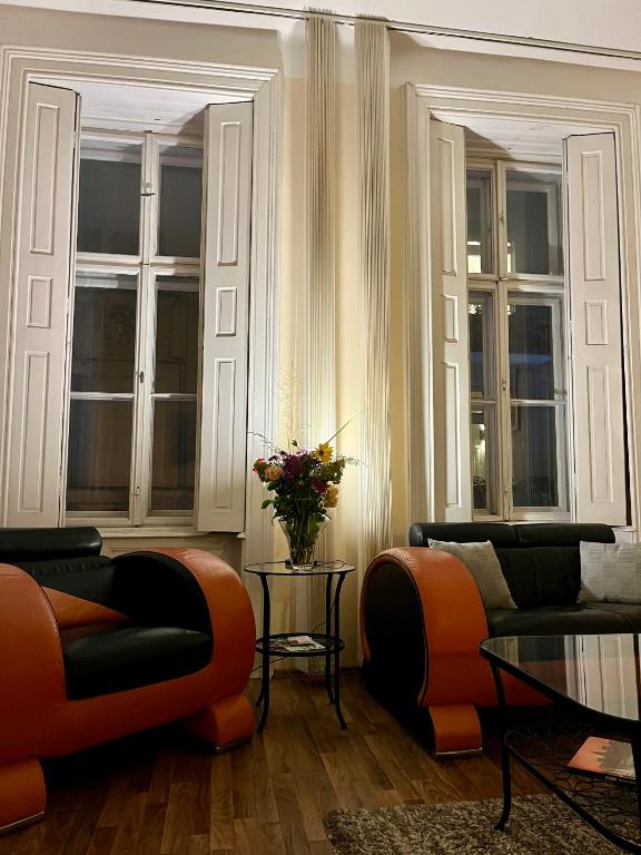 a living room with two couches and a table at Pyvo Street Home with balcony near the Danube in Budapest