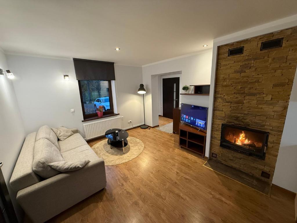 a living room with a couch and a fireplace at The Guugers 
