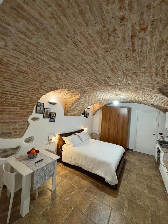 a bedroom with a bed and a stone wall at Ca' D'Rosina in Narzole