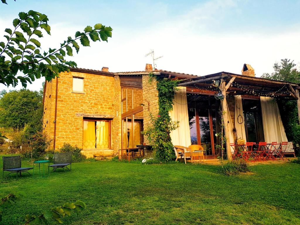 a brick house with a lawn in front of it at TERRALUNA Villa Vacanze San Leo - San Marino in San Leo