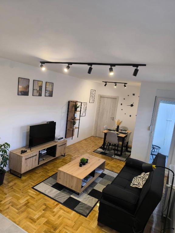 a living room with a couch and a table at Apartman Stefani in Pirot