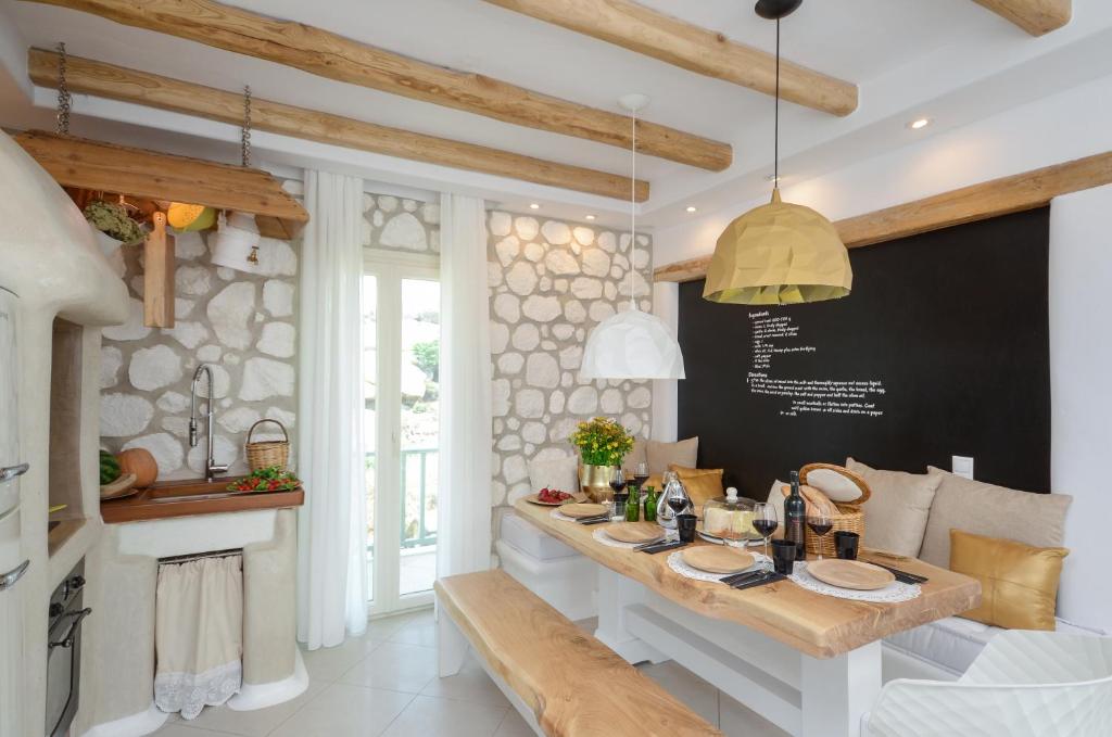 a dining room with a table and a blackboard at Naxos Euphoria Suites in Stelida