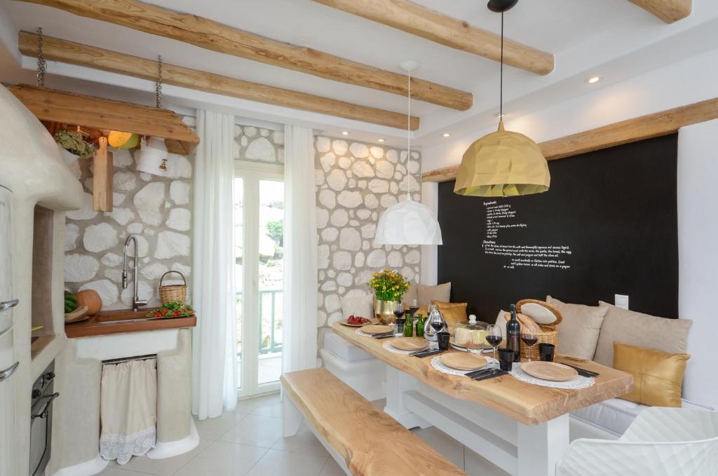 uma sala de jantar com uma mesa e um quadro-negro em Naxos Euphoria Suites em Stelida