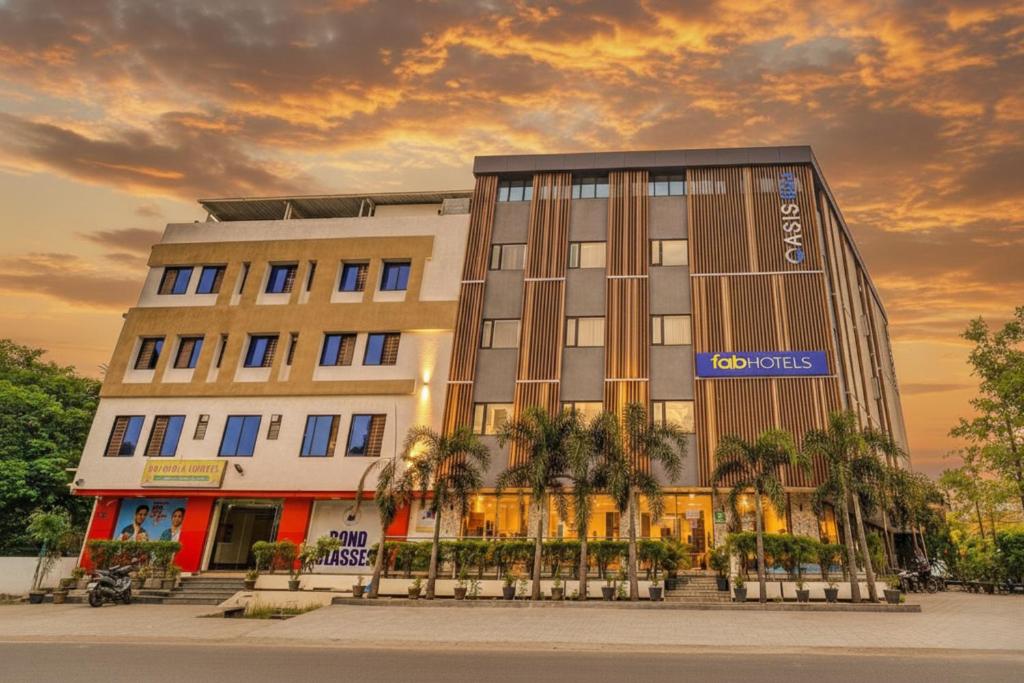a building with a clock on the side of it at FabHotel Prime Oasis Blue - Near Chetak Bridge in Bhopal