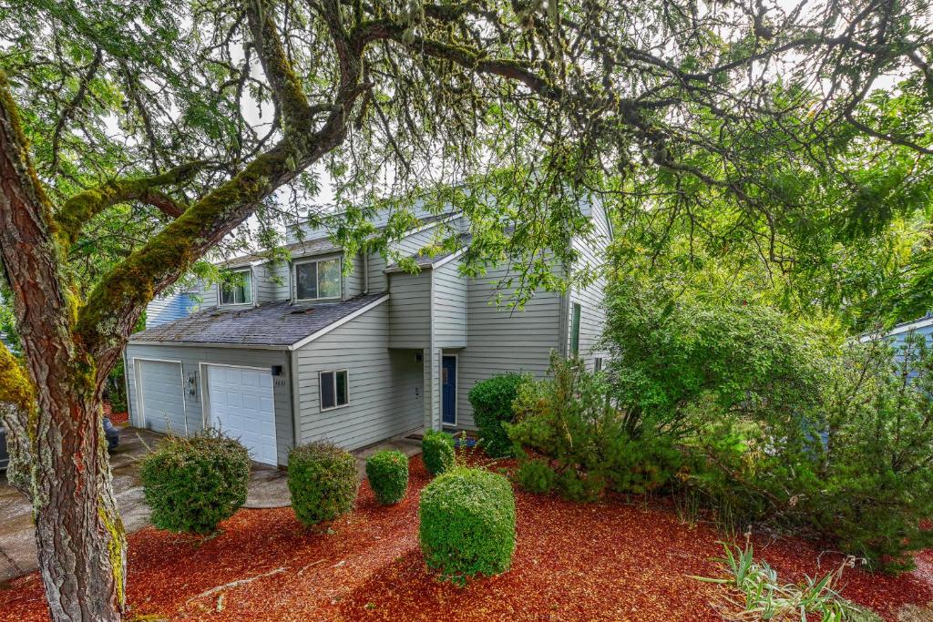 a white house with a tree and some bushes at Cozy 3-Bedroom Townhome - 3 Miles from OSU! in Corvallis