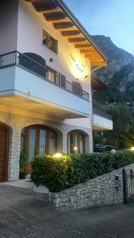 a large white building with a balcony on top at Villa Gianna 3 in Limone sul Garda