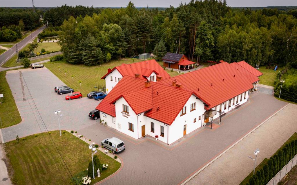an overhead view of a large white building with an orange roof at Dom Weselny Izabela Noclegi in Osiek
