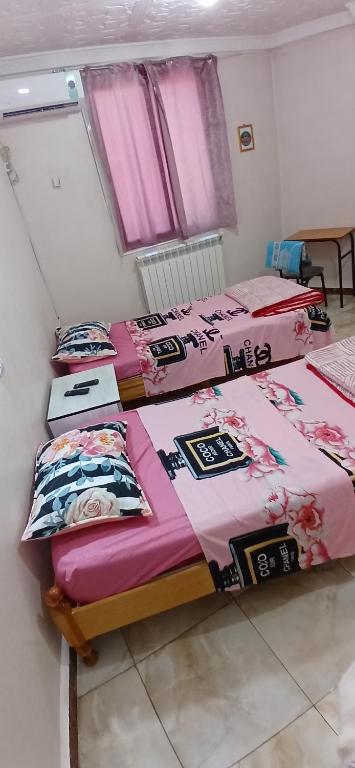 a group of three beds in a room at hostel 1er novembre khenchela in Khenchela