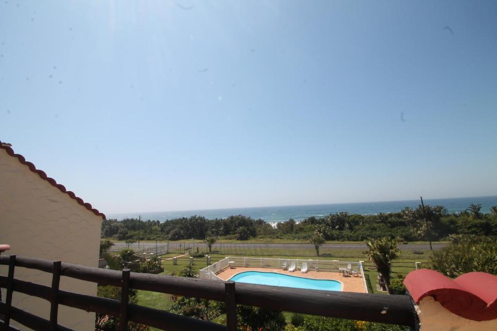 a view of a swimming pool from a house at La Corsica 17, Uvongo in Margate
