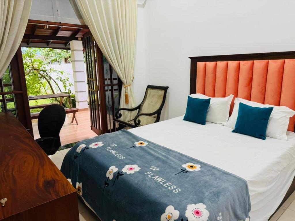 Un dormitorio con una cama con flores. en Villa Sea Breeze, en Beruwala