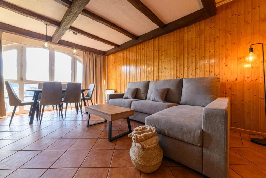 a living room with a couch and a table at Chalet Copos Nevados by Surynieve in Sierra Nevada