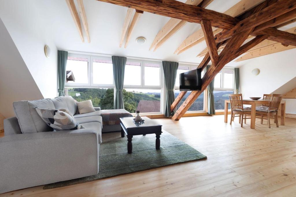 a living room with a couch and a table at Panoramablick Bucklige Welt in Edlitz