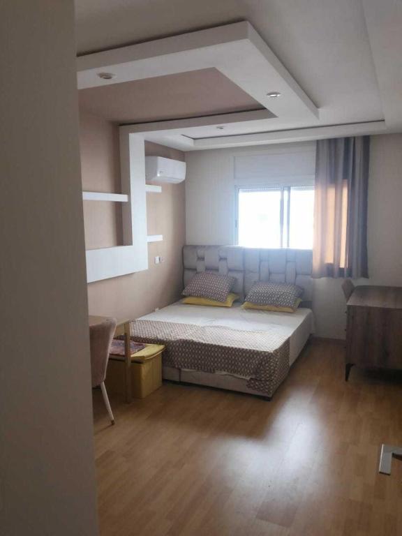 a bedroom with a large bed in a room at Studio Charmant & Cosy à Agdal in Gare de Rabat-Aguedal