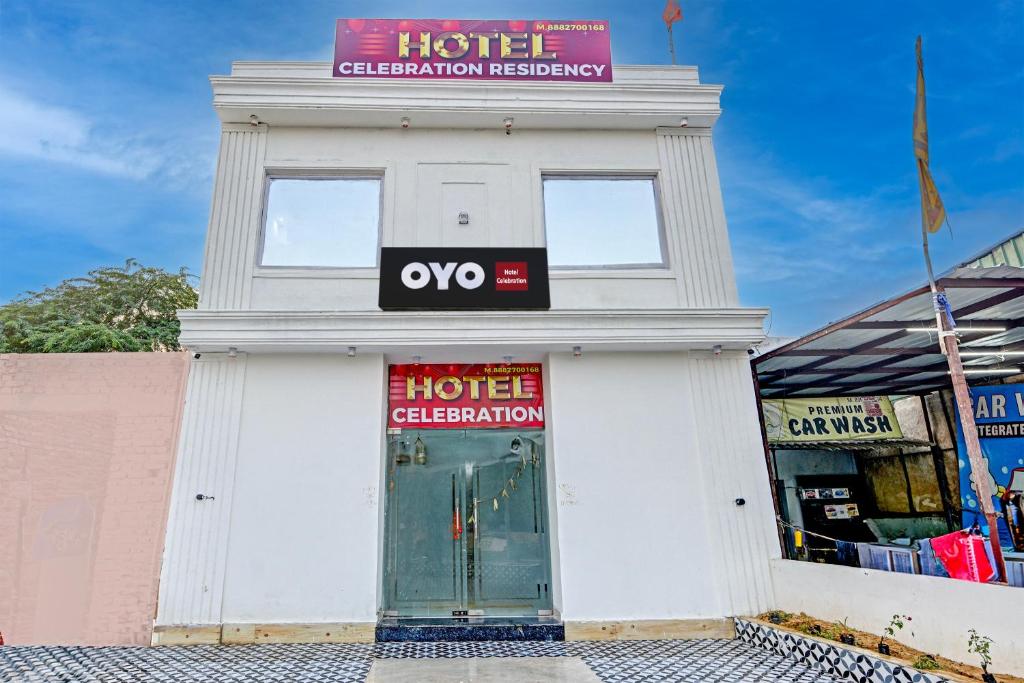 a white building with a hotel sign on it at Hotel O Celebration in Indraprast