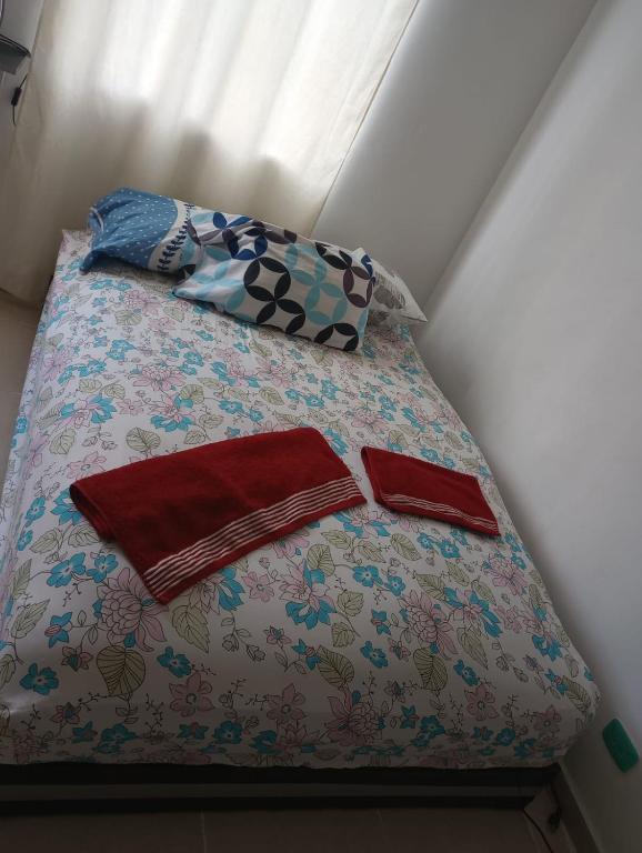 a bed with two pillows on top of it at Deluxury in Santa Marta
