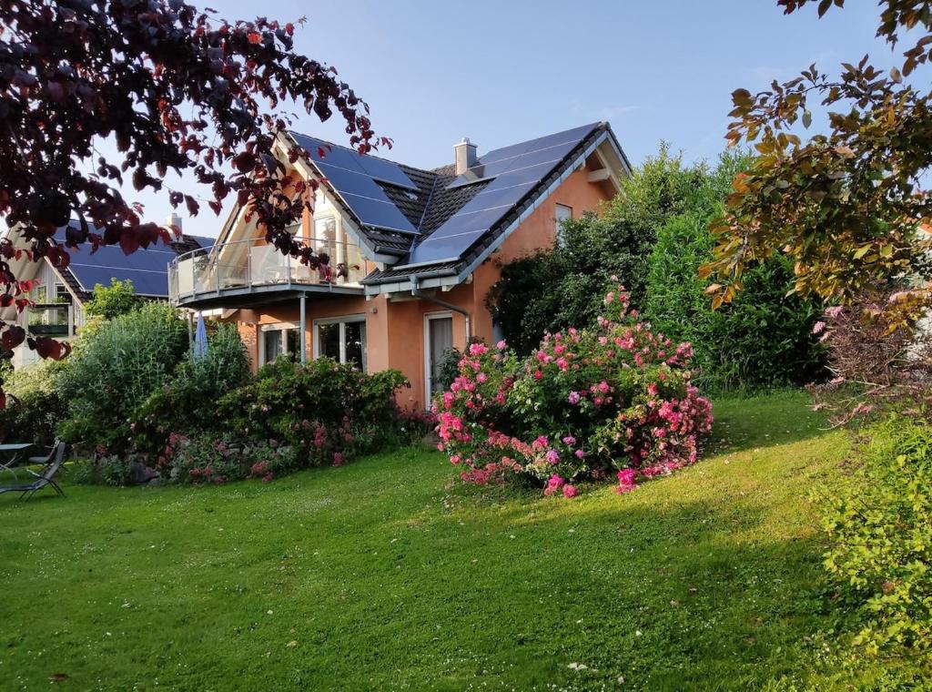 a house with a yard with flowers at Casa Luna in Herdwangen-Schönach