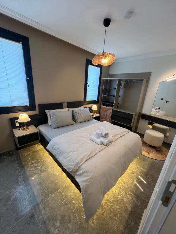 a bedroom with a large white bed and a mirror at Mirşah Suit in Bezkesen