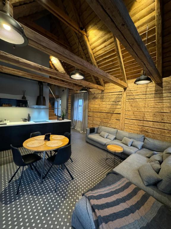 a living room with a couch and a table at Garden House in Liepāja