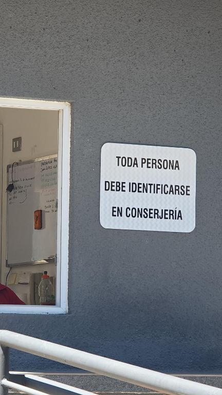 a sign on a wall that reads toga pvezonia disease indifference encom at Departamentos rancagua in Rancagua