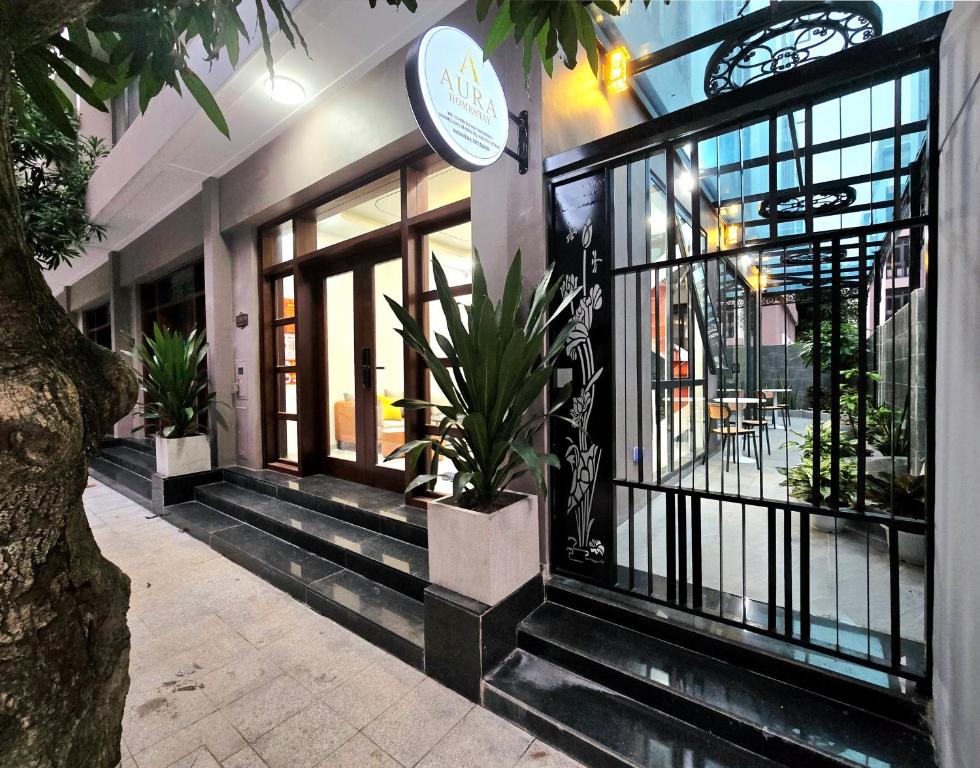 a building with potted plants on the front of it at Aura Homestay in Cửu Cảo