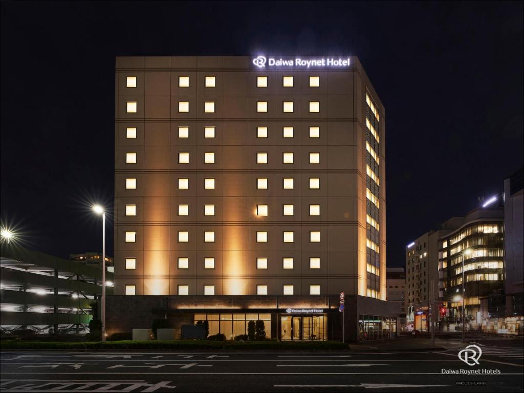 a building with a lit up sign on top of it at Daiwa Roynet Utsunomiya in Utsunomiya
