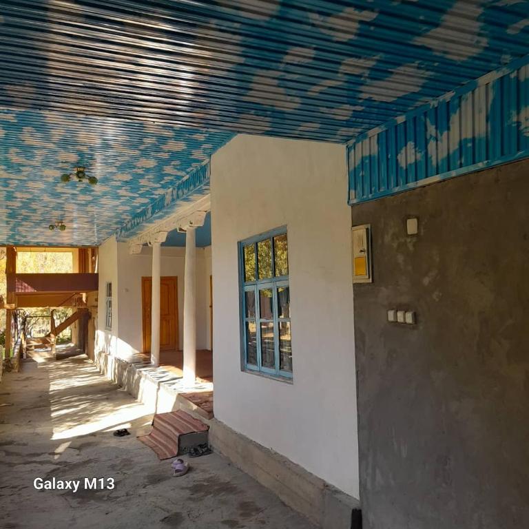 a room with a ceiling with blue tiles on it at Gasthaus Jasur,Yakkakhona 