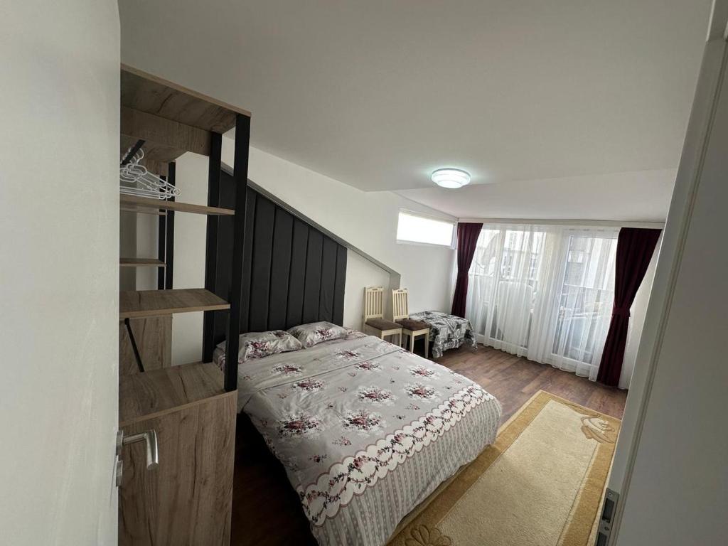 a bedroom with a bed with a wooden headboard at Heart of prishtina apartaments 5 in Pristina
