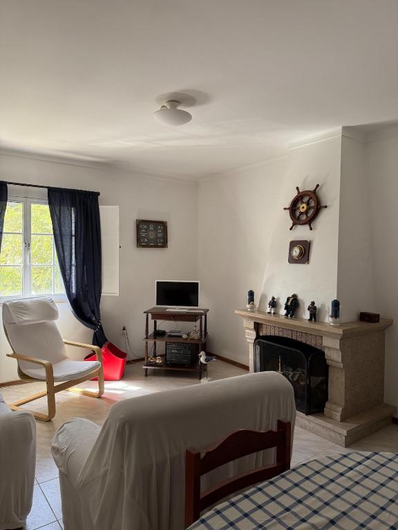 a living room with a fireplace and a couch at Casa Macedo in Vila Real de Santo António