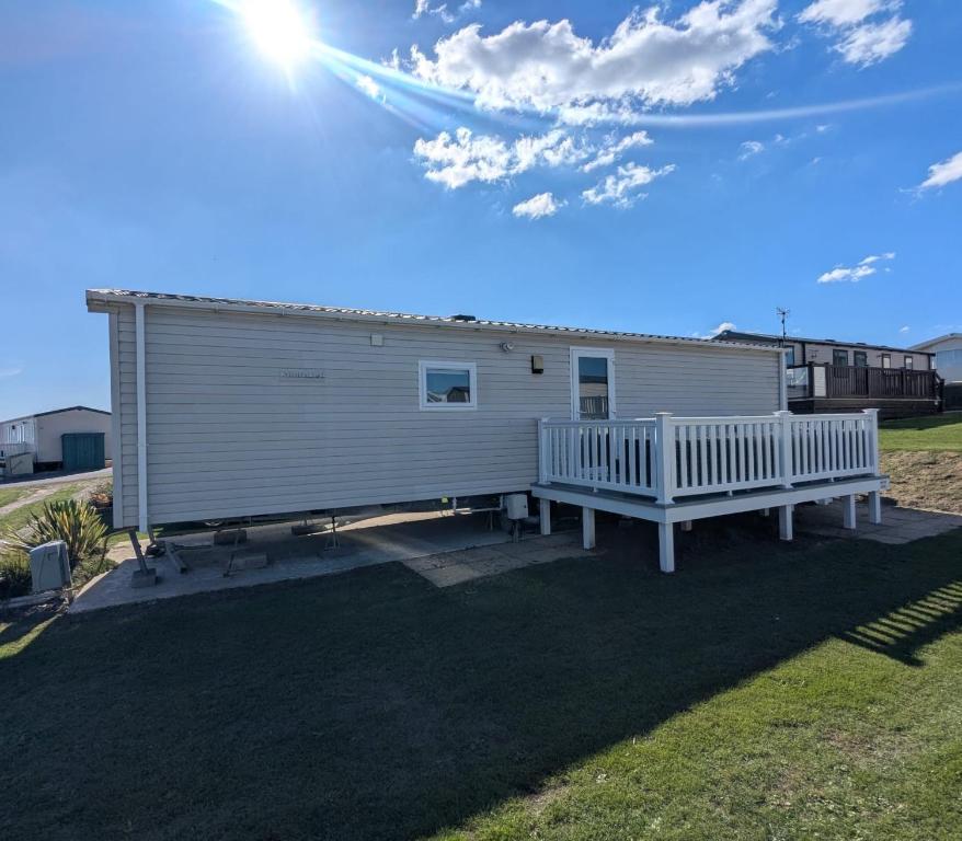 a mobile home with a porch and a house at Modern Style Pet Friendly Holiday Home sited on Durdle Door Holiday Park in West Lulworth